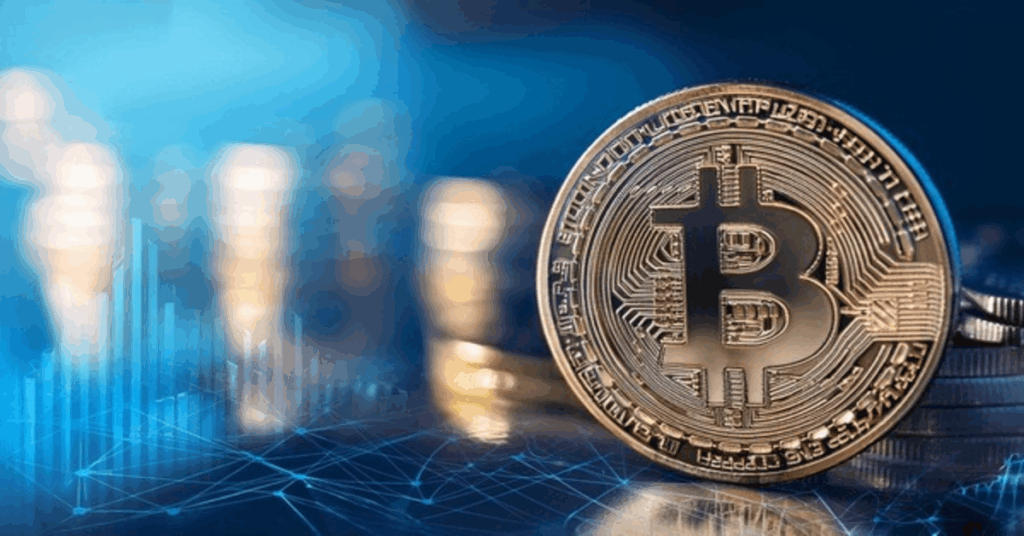 Moeda Bitcoin em destaque com gráficos de mercado ao fundo, representando o impacto das criptomoedas e blockchain nas finanças.